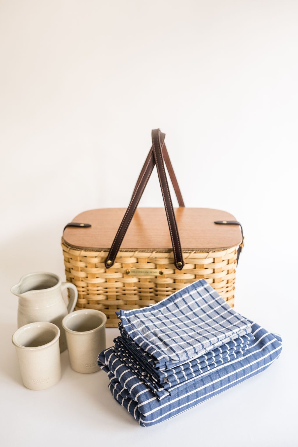 Cloth Napkins Folded on Top of Each Other Next to a Basket