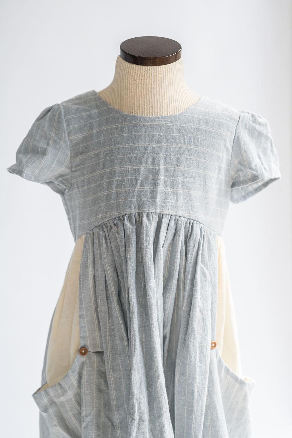 The Children's Linen Dress on a Mannequin