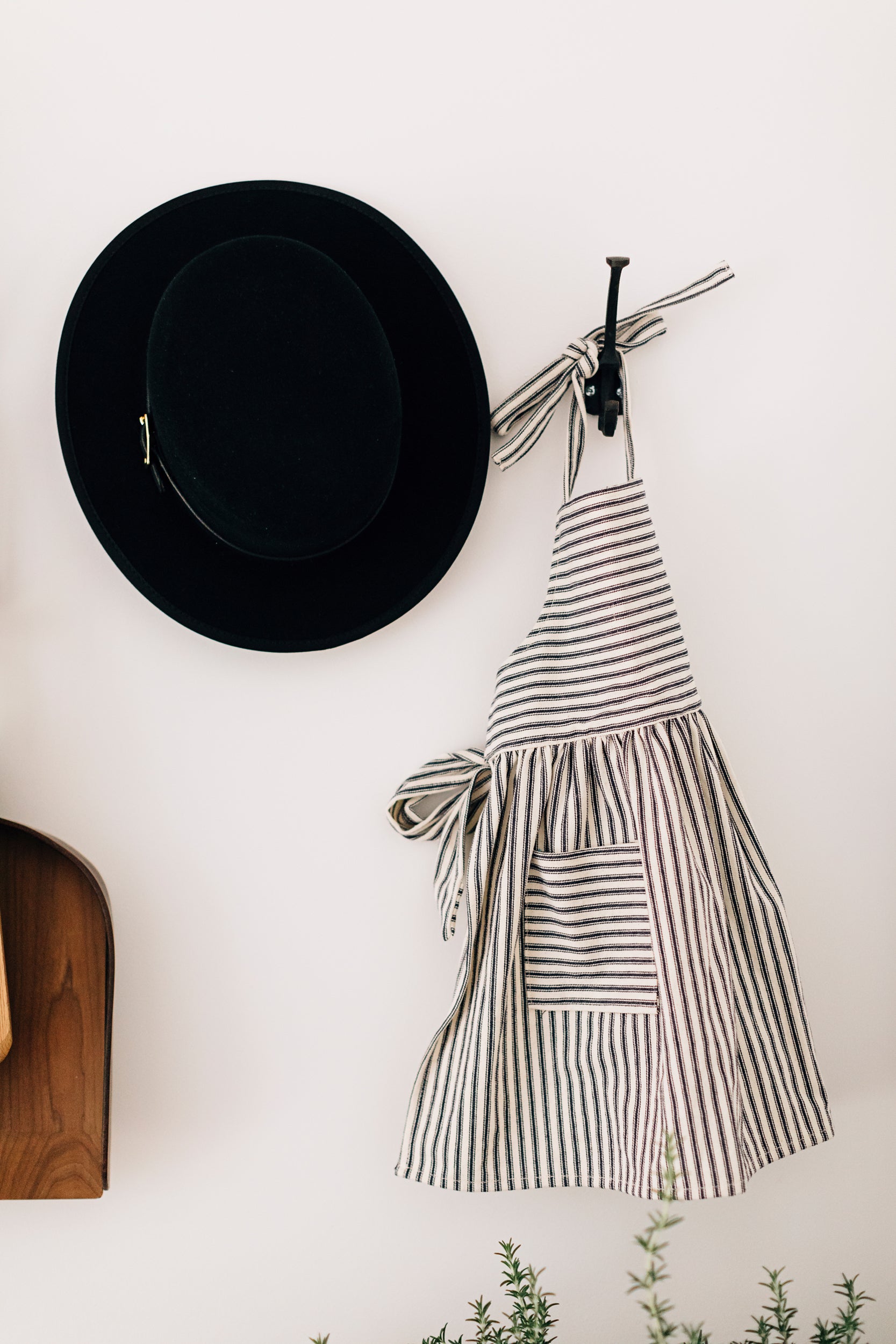 The Child's Ticking Apron Hanging on a Wall