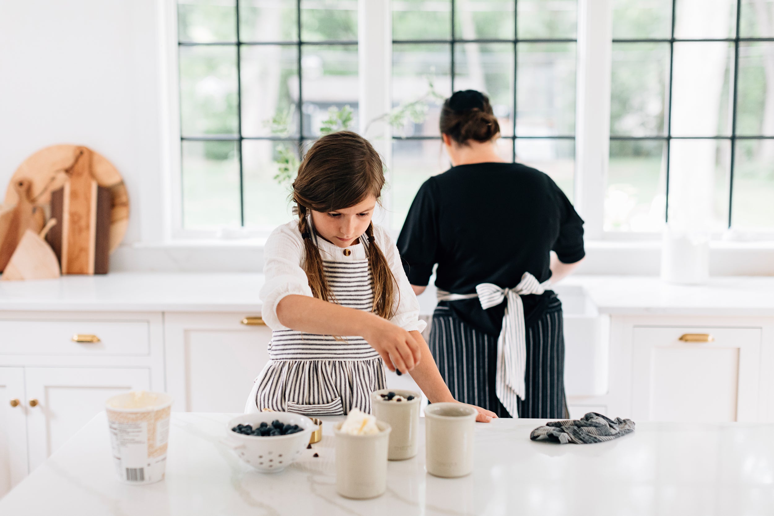 The Child's Ticking Apron on a Child in a Kitchen